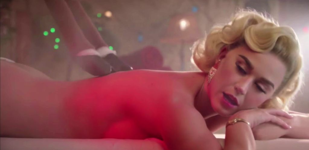 Katy Perry strips off and flashes her bum in the Cozy Little Christmas vid